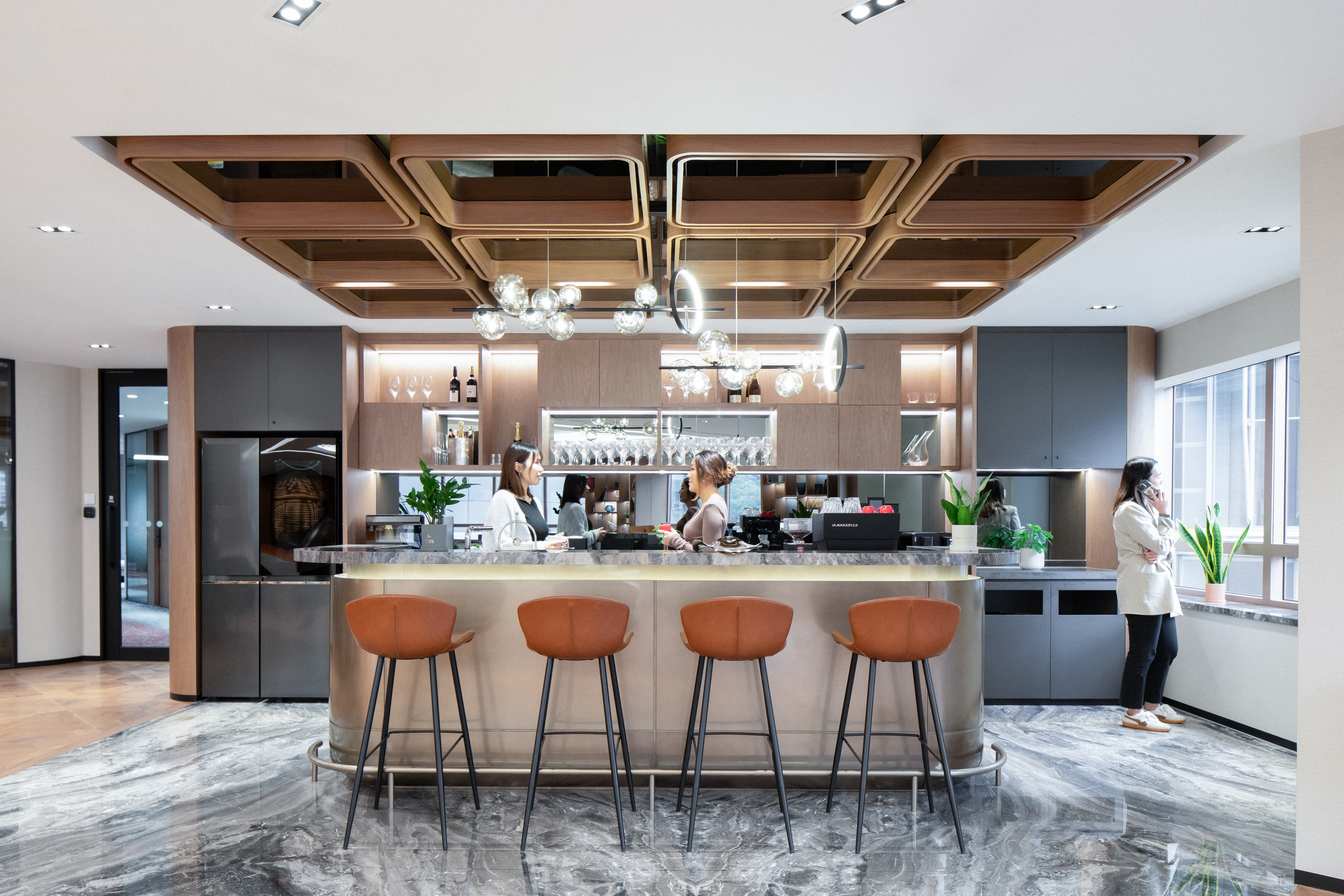 Various amenities, including the pantry (left) and wellness room (right), are thoughtfully designed to enhance the well-being of office workers